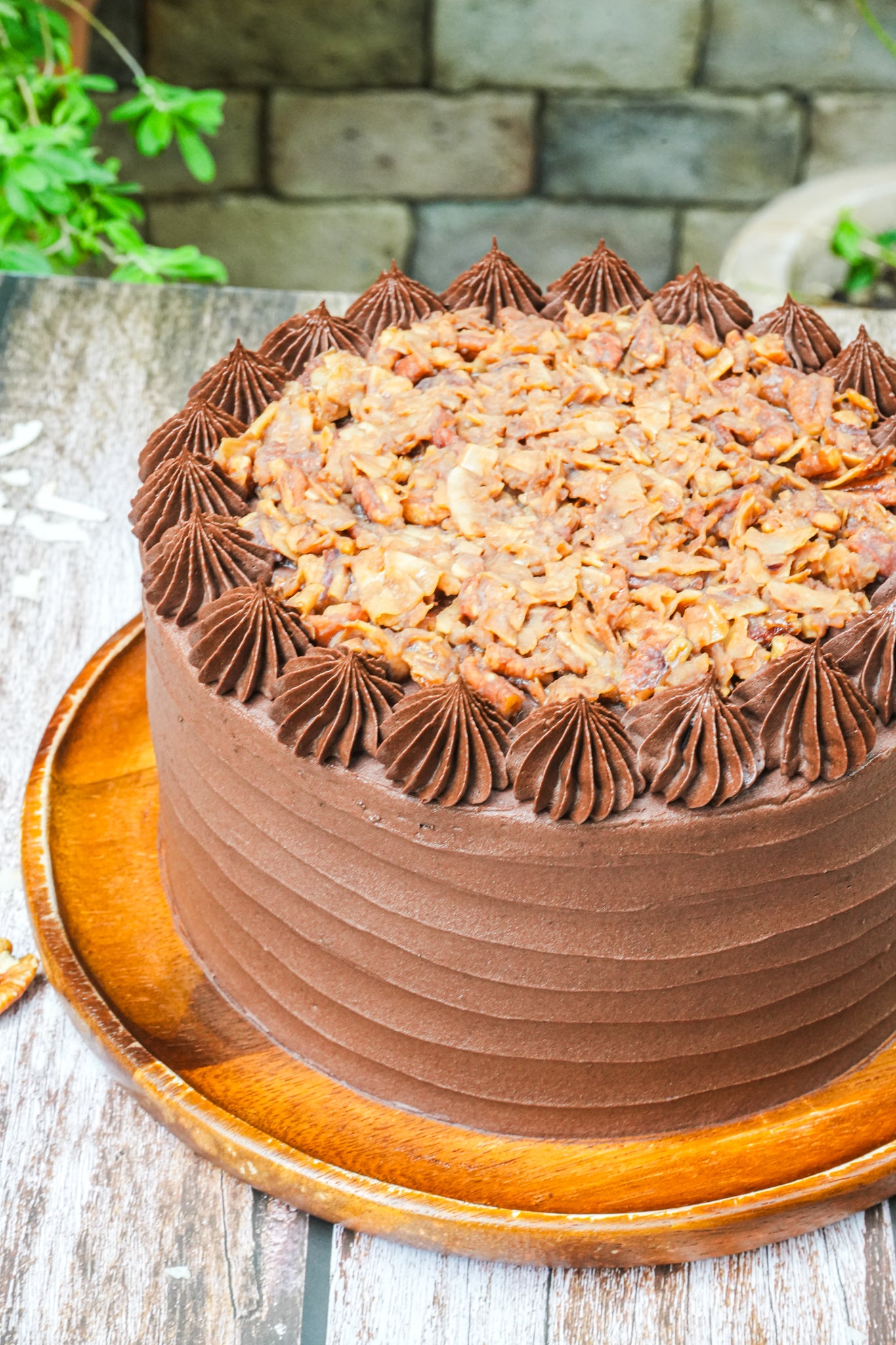 Soft chocolate cake layered with coconut flakes and pecans covered with a fudge chocolate frosting.