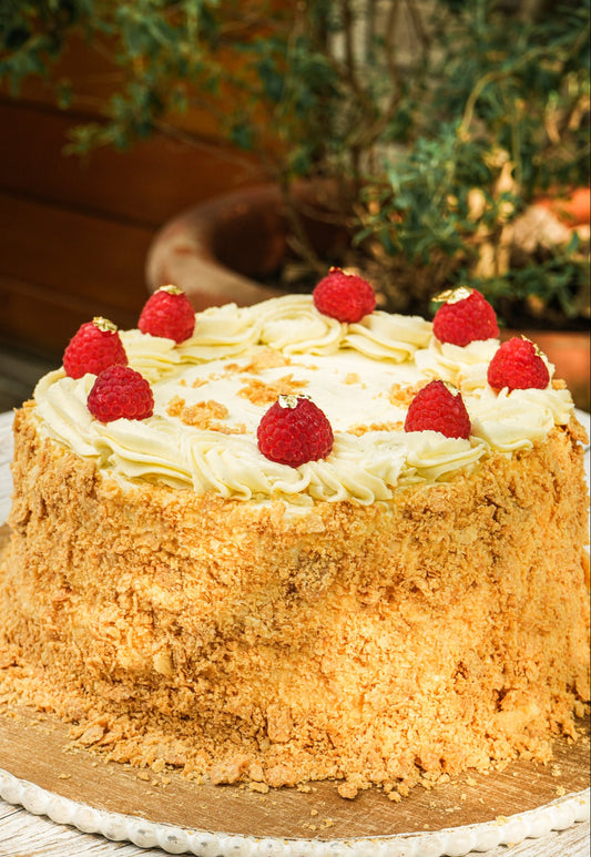 Layered chilean cake with crispy pastry layers, pastry cream and raspberries.